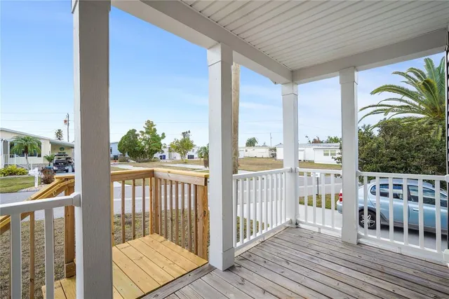 a view of a balcony with wooden floor