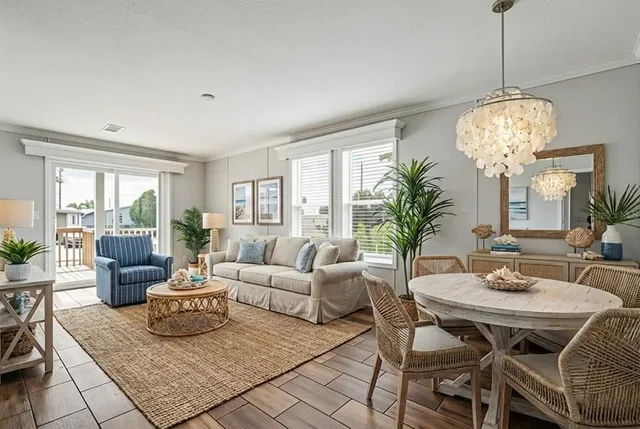 a living room with fireplace furniture and a chandelier