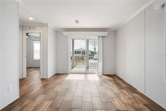 wooden floor in an empty room with a window