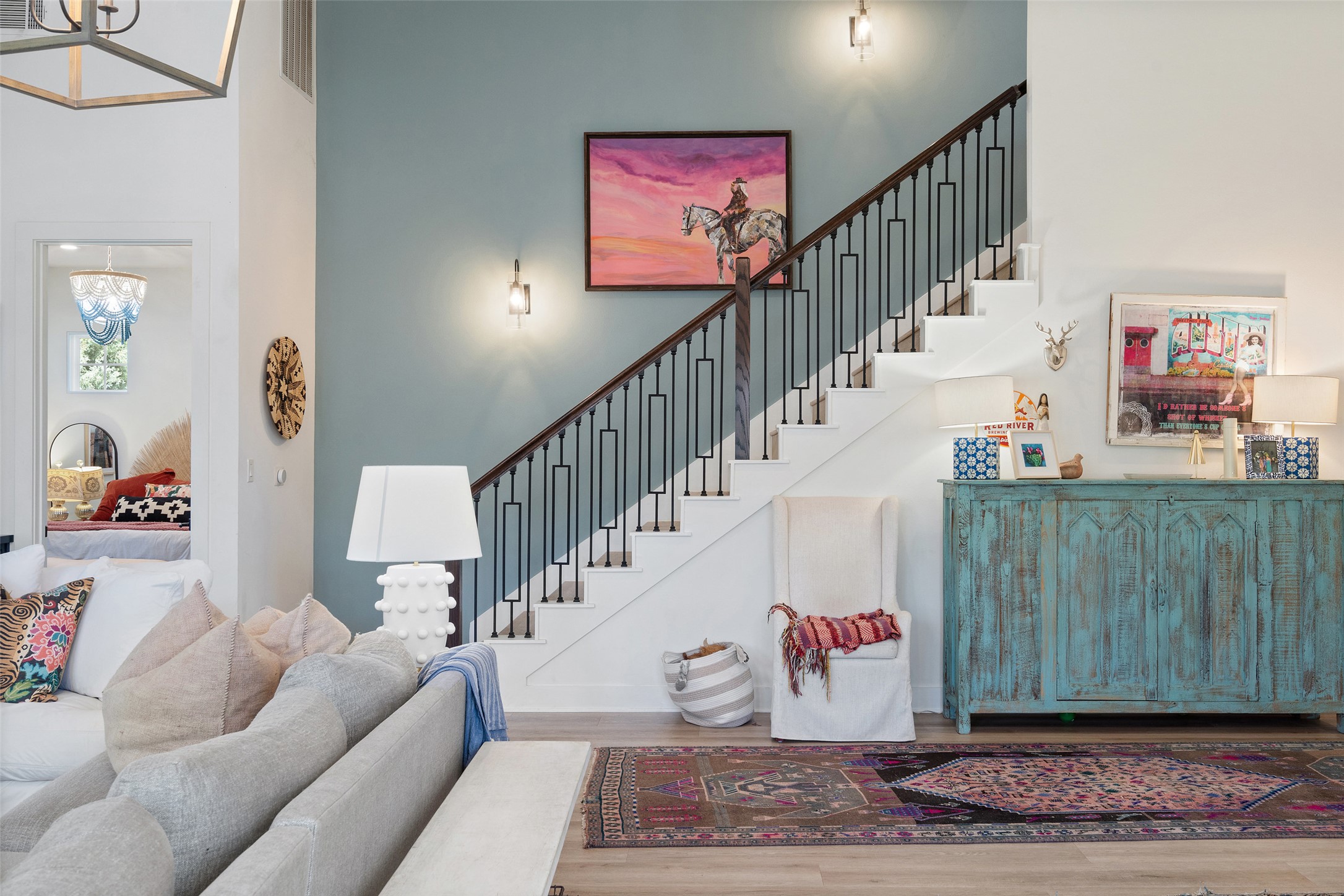 170 Bunker Rnch Boulevard, Unit 28 Dripping Springs, TX 78620 - Photo 15 of 37 Stairway with wood finished floors, a chandelier, and a high ceiling