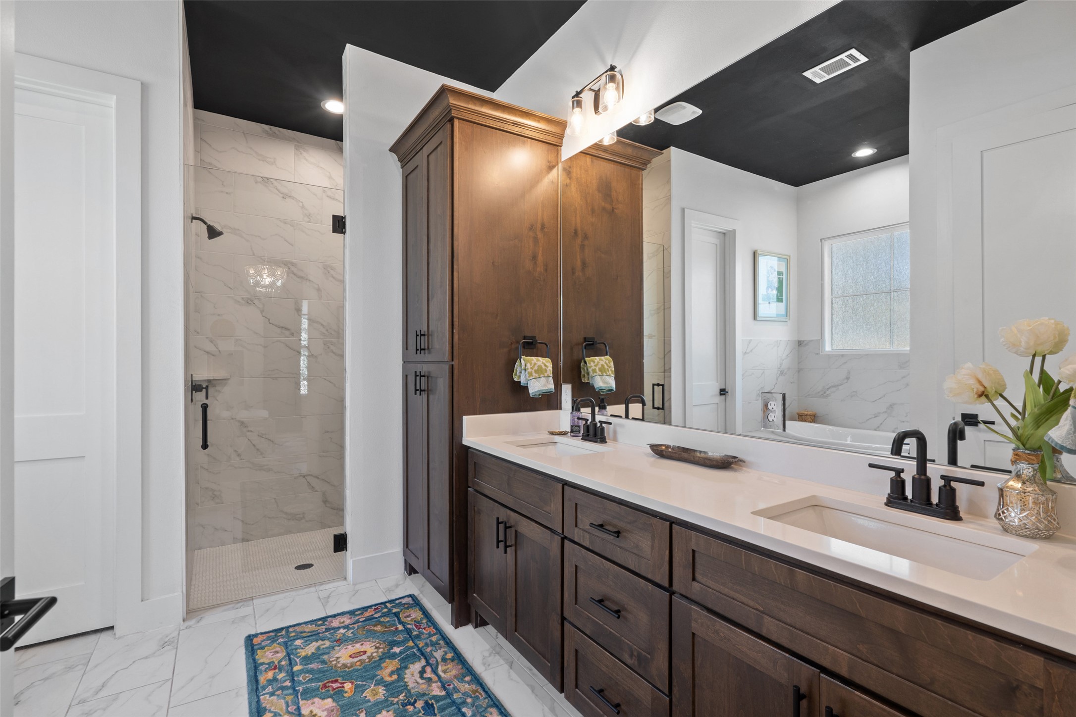 170 Bunker Rnch Boulevard, Unit 28 Dripping Springs, TX 78620 - Photo 19 of 37 Full bath with double vanity, a marble finish shower, and light marble finish flooring