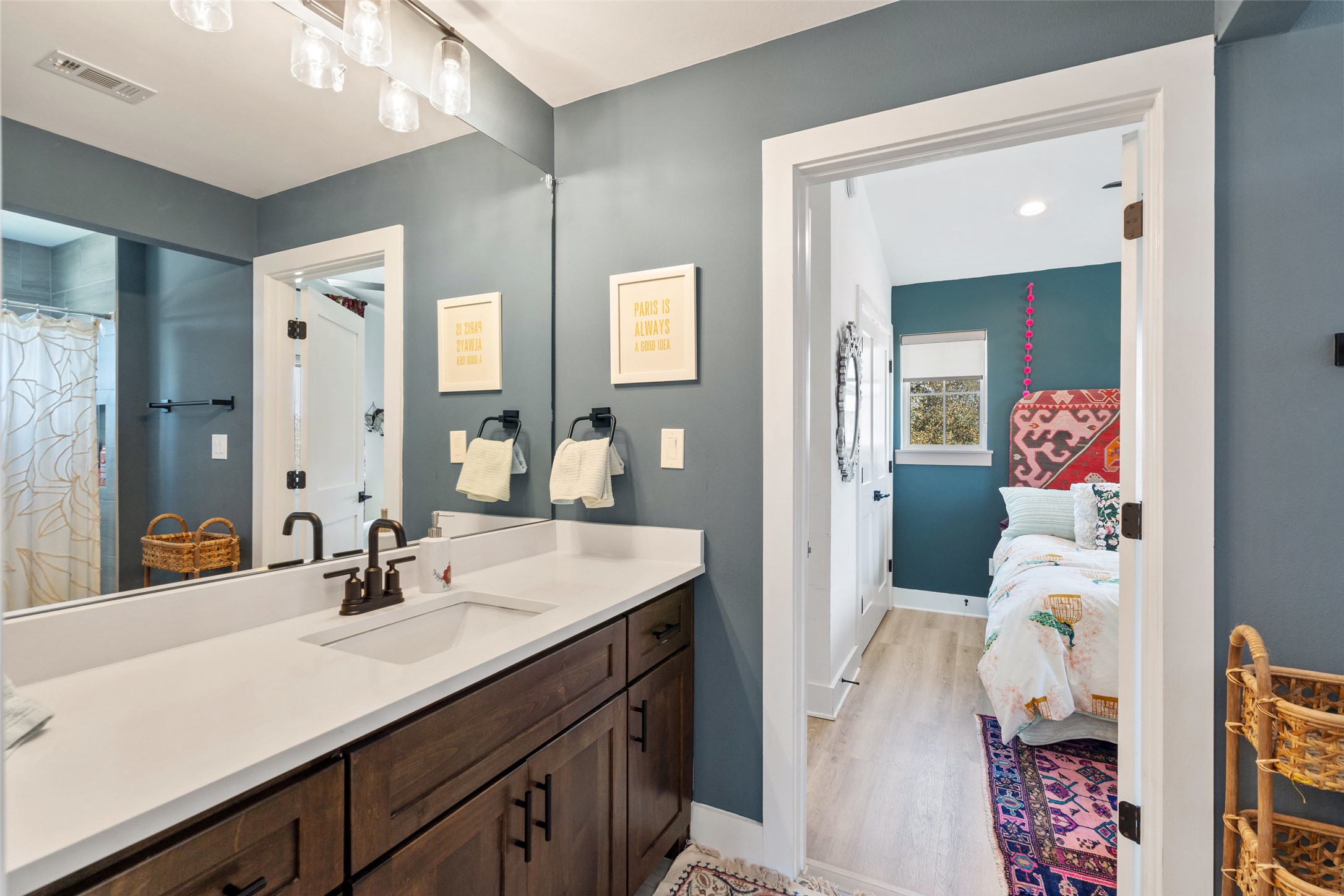 170 Bunker Rnch Boulevard, Unit 28 Dripping Springs, TX 78620 - Photo 22 of 37 Ensuite bathroom featuring vanity, a shower with shower curtain, and light wood-style flooring