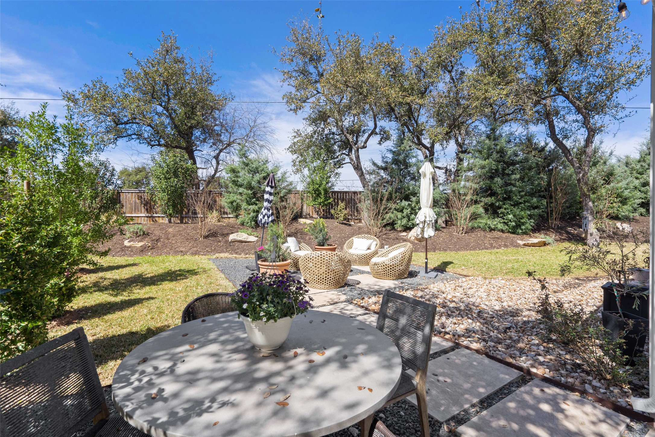 170 Bunker Rnch Boulevard, Unit 28 Dripping Springs, TX 78620 - Photo 31 of 37 Fenced backyard featuring a patio and outdoor dining area