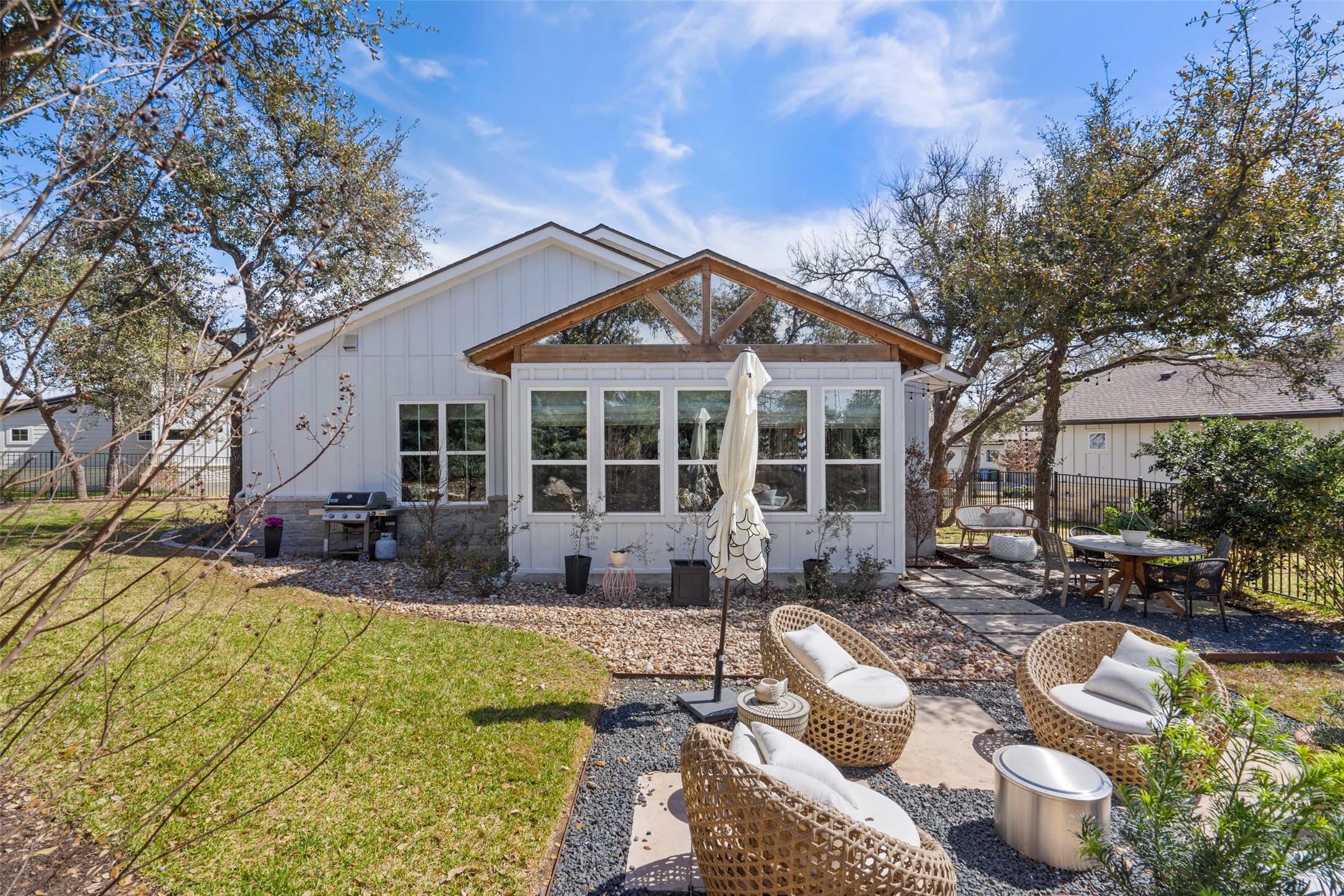 170 Bunker Rnch Boulevard, Unit 28 Dripping Springs, TX 78620 - Photo 33 of 37 Back of property featuring board and batten siding, outdoor dining area, and a patio