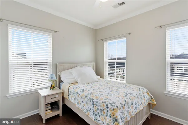 a bedroom with a bed next to a window