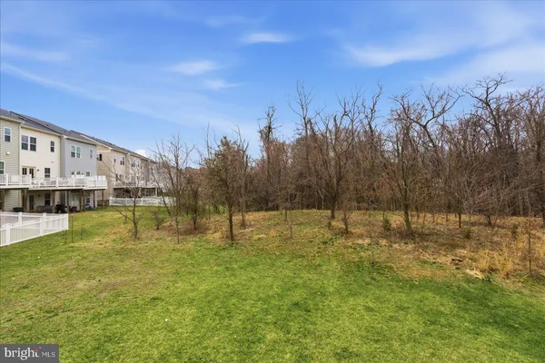a swimming pool with an outdoor seating and a yard