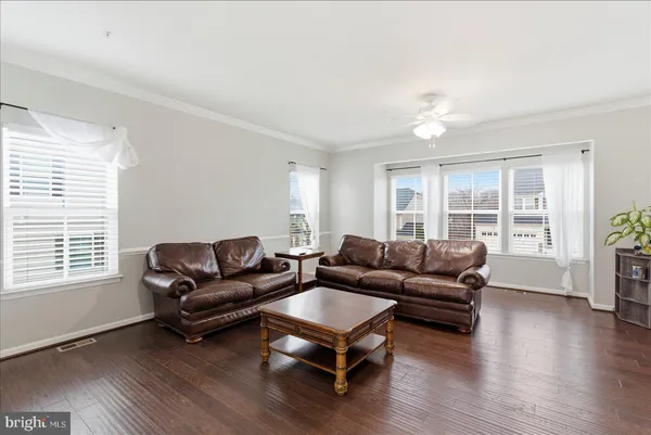 a living room with furniture window and wooden floor