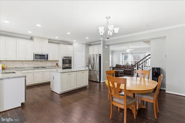 a view of a dining room with furniture kitchen and chandelier