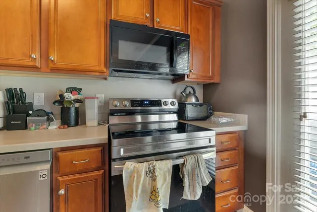 a kitchen with stainless steel appliances granite countertop a sink and cabinets