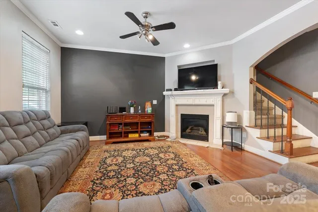 a living room with furniture a flat screen tv and a fireplace