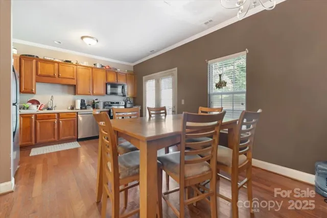 a view of a dining room with furniture and window