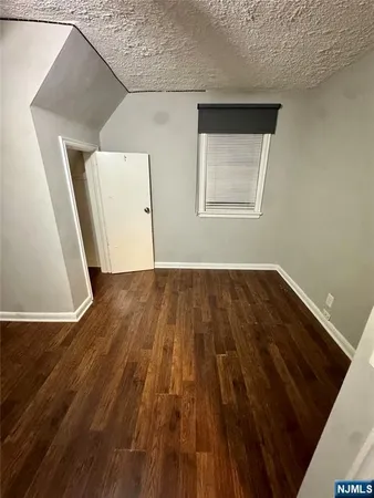a view of a livingroom with wooden floor and a ceiling fan