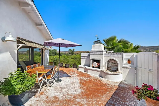 a view of a chairs and table in backyard