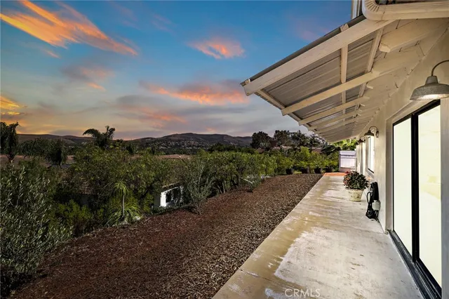 a view of a street with a wooden fence