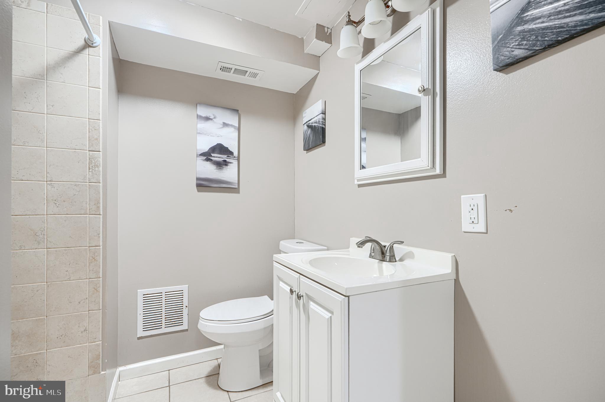 315 Overlea Place Abingdon, MD 21009 - Photo 47 of 56 a bathroom with a toilet sink and mirror