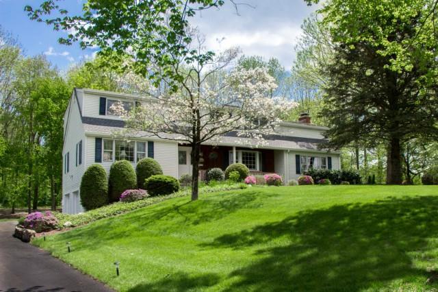 195 Holmes Road Ridgefield, CT 06877 - Photo 1 of 1 a front view of a house with garden and trees
