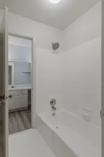 a bathroom with a bathtub and a sink