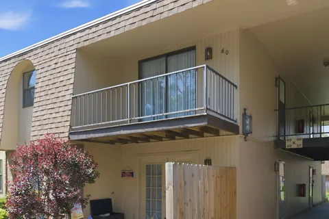 a view of a house with a wooden fence