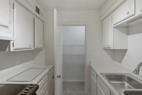 a kitchen that has a sink and a stove