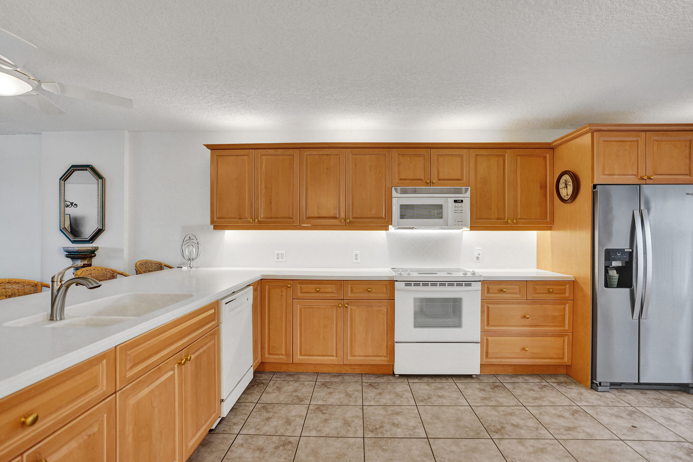 1627 Riverview Road, Unit 410 Deerfield Beach, FL 33441 - Photo 13 of 56 a kitchen with stainless steel appliances granite countertop a stove a sink and a refrigerator