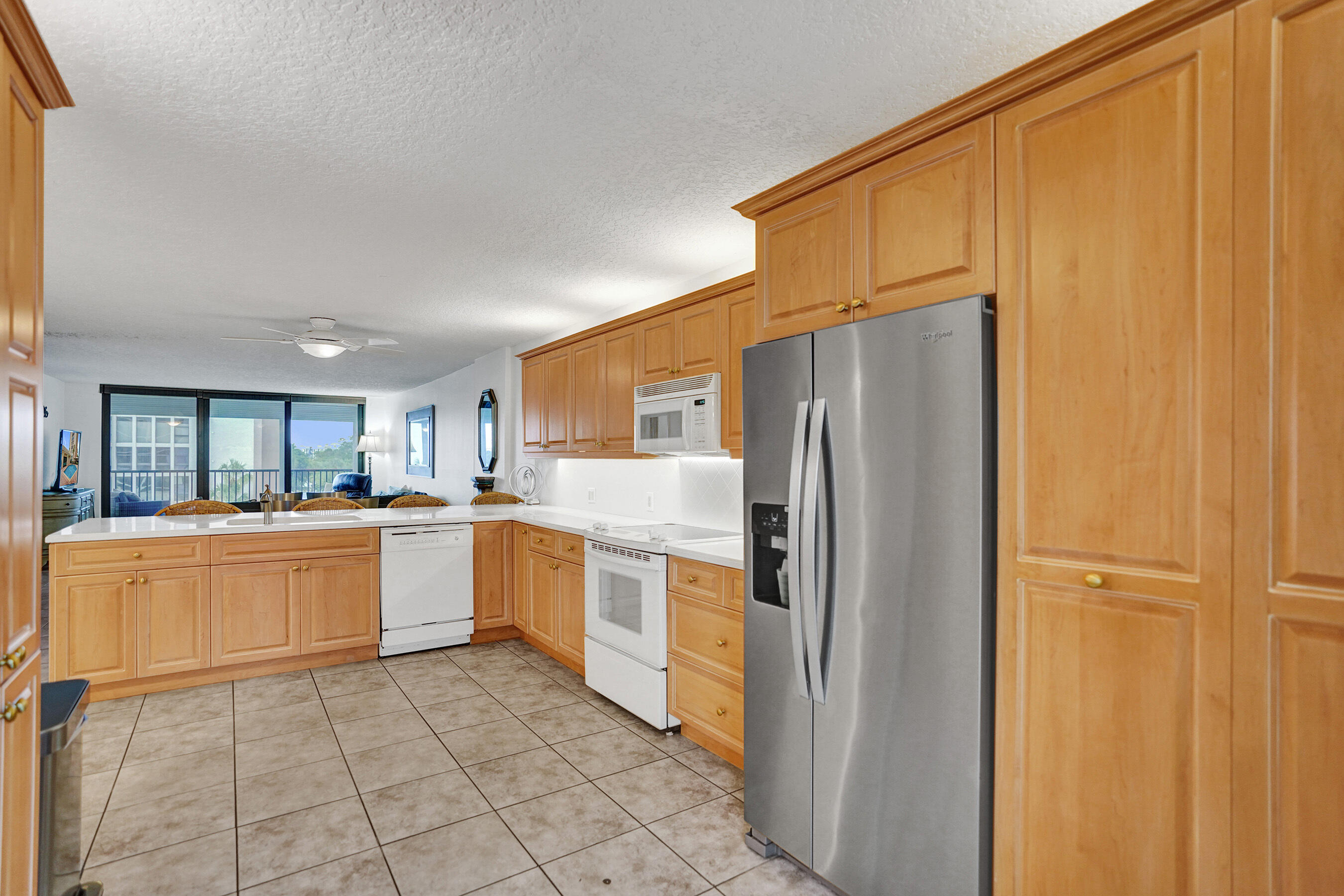 1627 Riverview Road, Unit 410 Deerfield Beach, FL 33441 - Photo 15 of 56 a kitchen with stainless steel appliances a refrigerator and a stove top oven