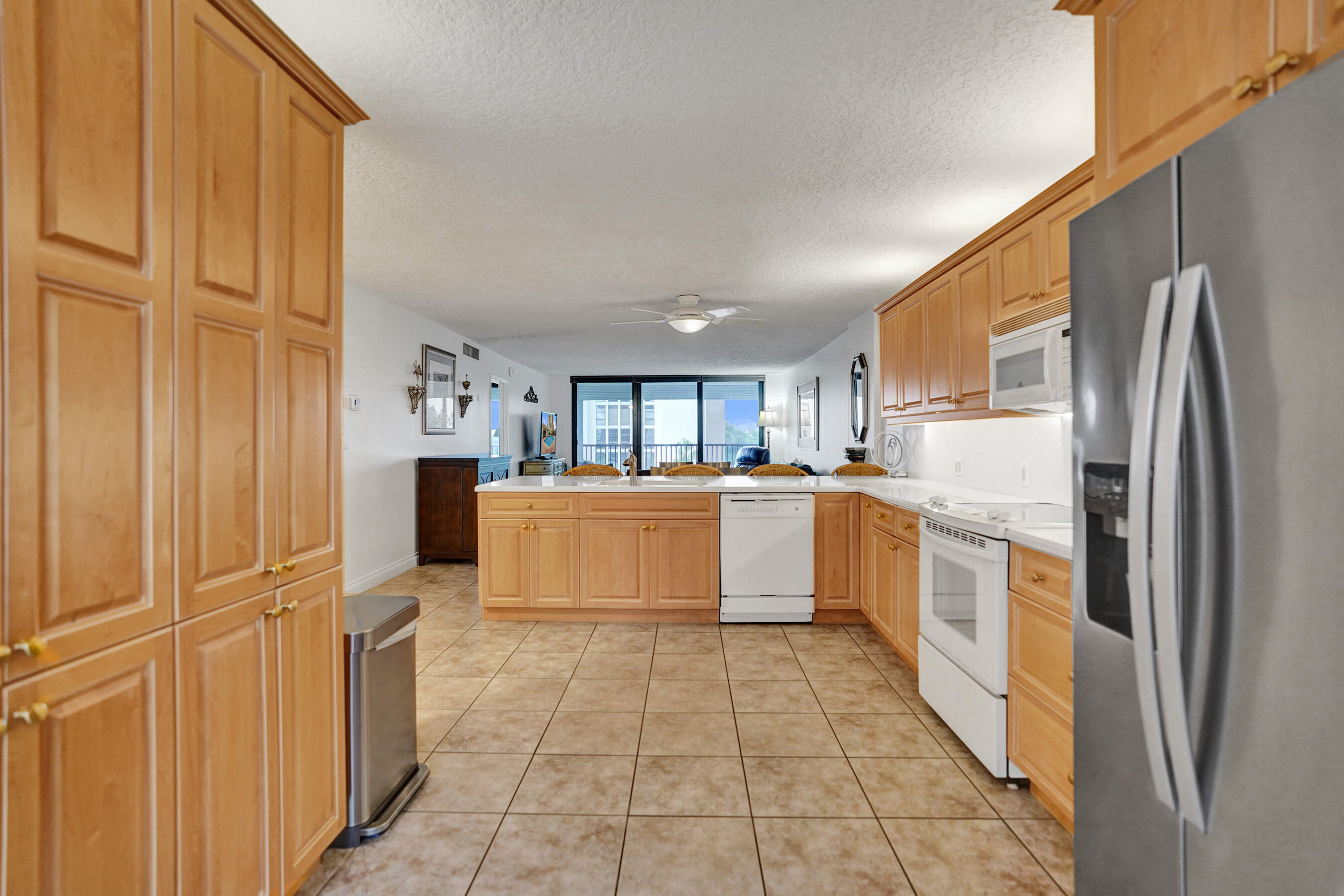 1627 Riverview Road, Unit 410 Deerfield Beach, FL 33441 - Photo 16 of 56 a large kitchen with stainless steel appliances granite countertop a refrigerator and a sink