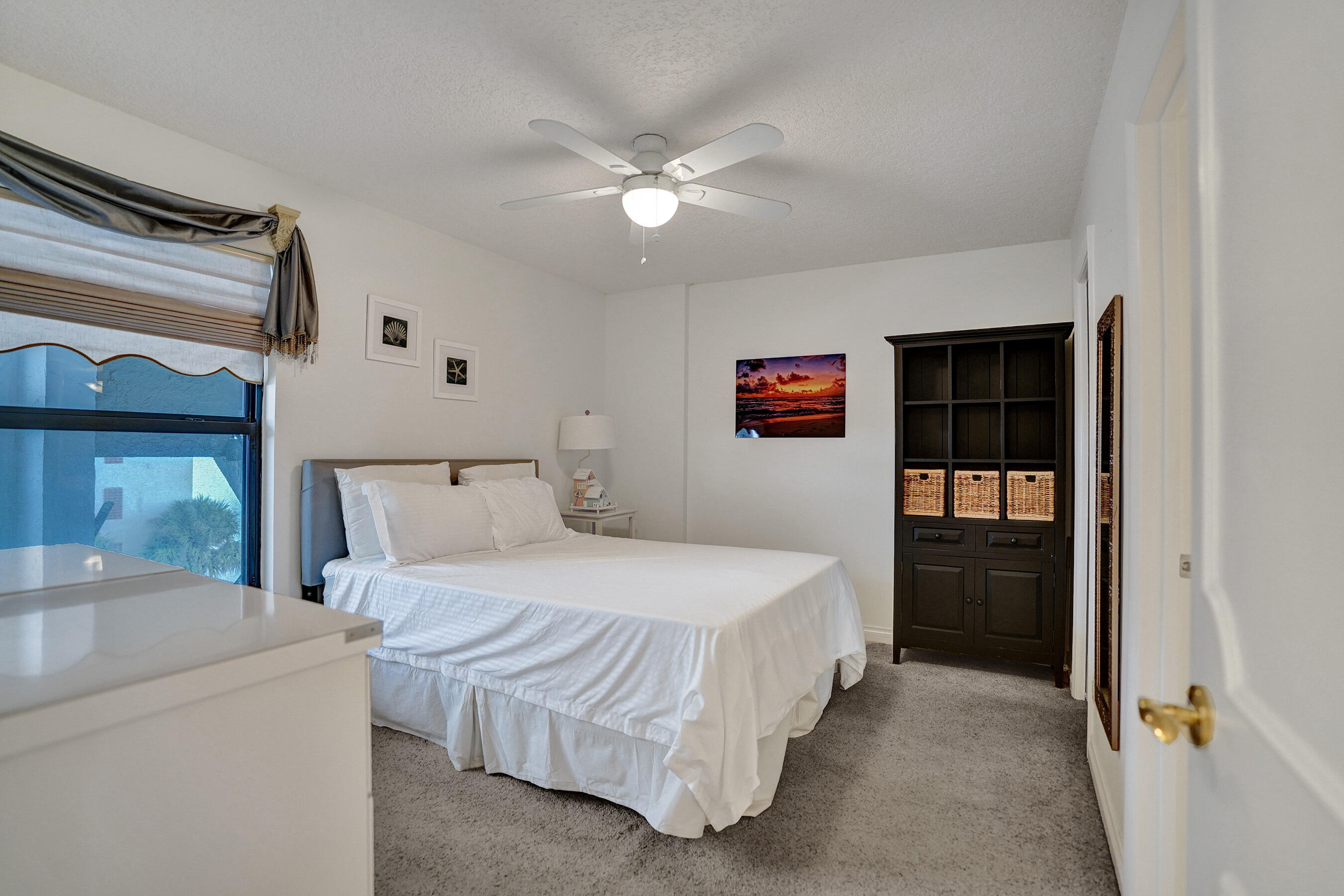 1627 Riverview Road, Unit 410 Deerfield Beach, FL 33441 - Photo 18 of 56 a bedroom with a bed and a refrigerator