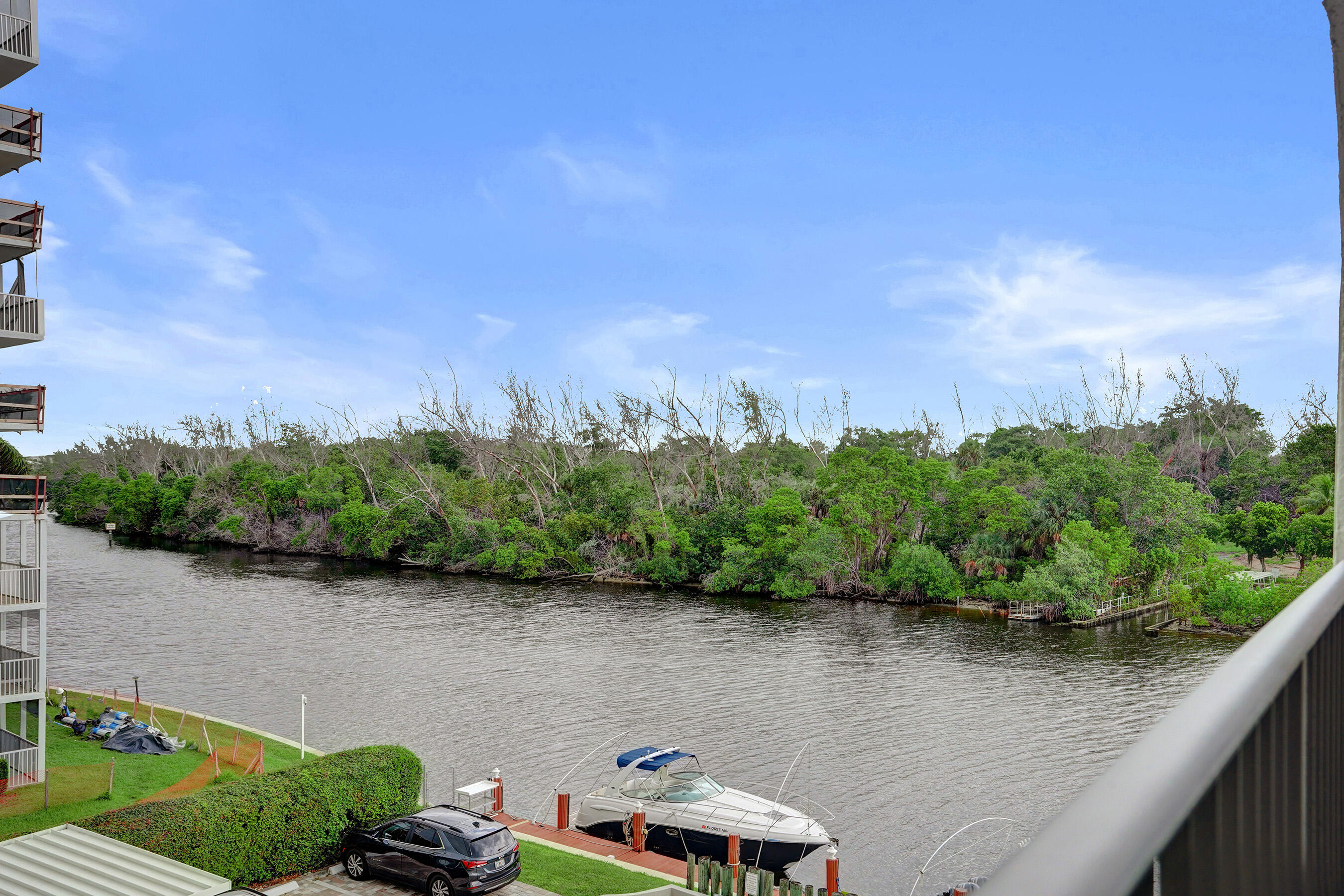 1627 Riverview Road, Unit 410 Deerfield Beach, FL 33441 - Photo 2 of 56 a view of a lake from a balcony