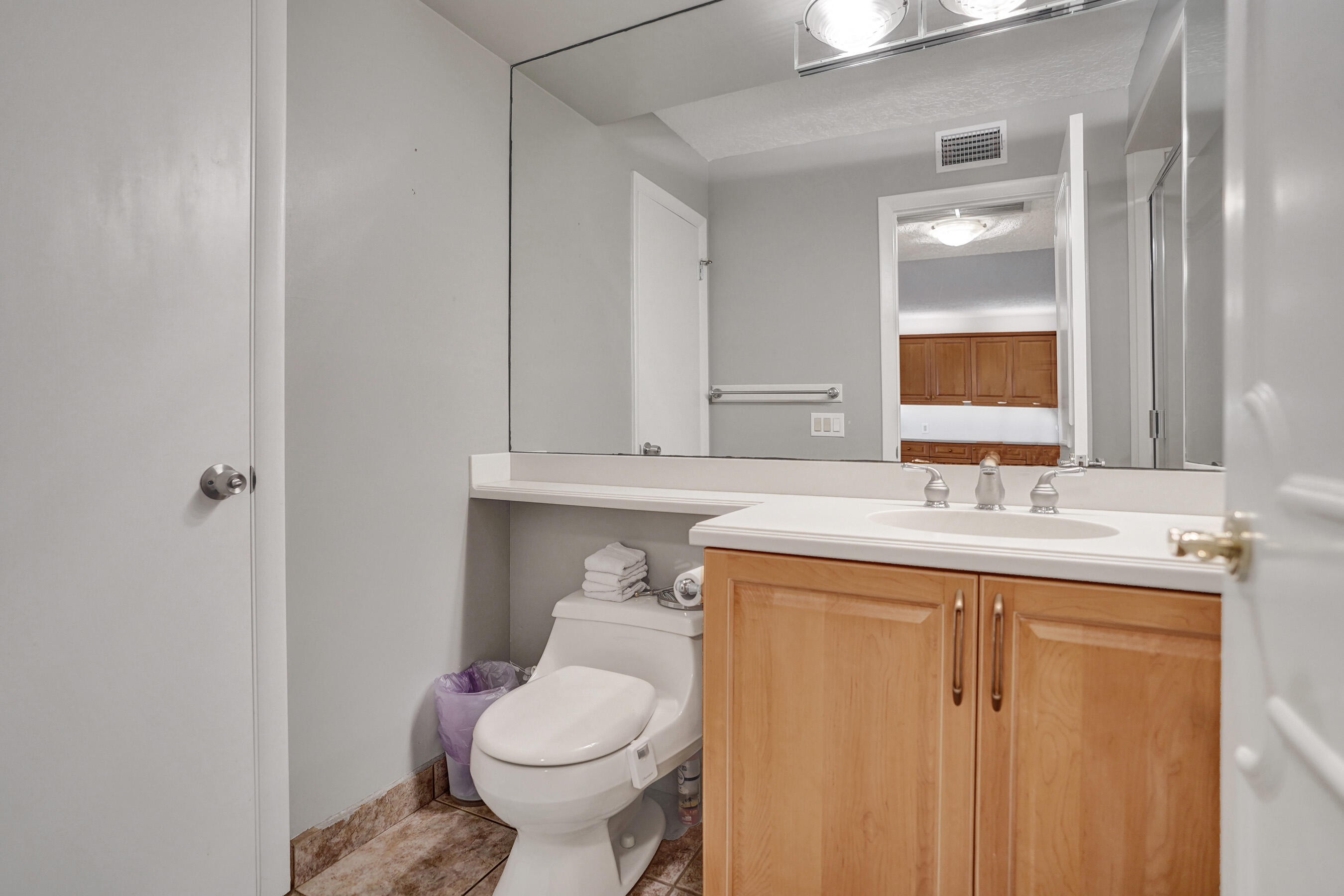 1627 Riverview Road, Unit 410 Deerfield Beach, FL 33441 - Photo 22 of 56 a bathroom with a sink toilet and vanity