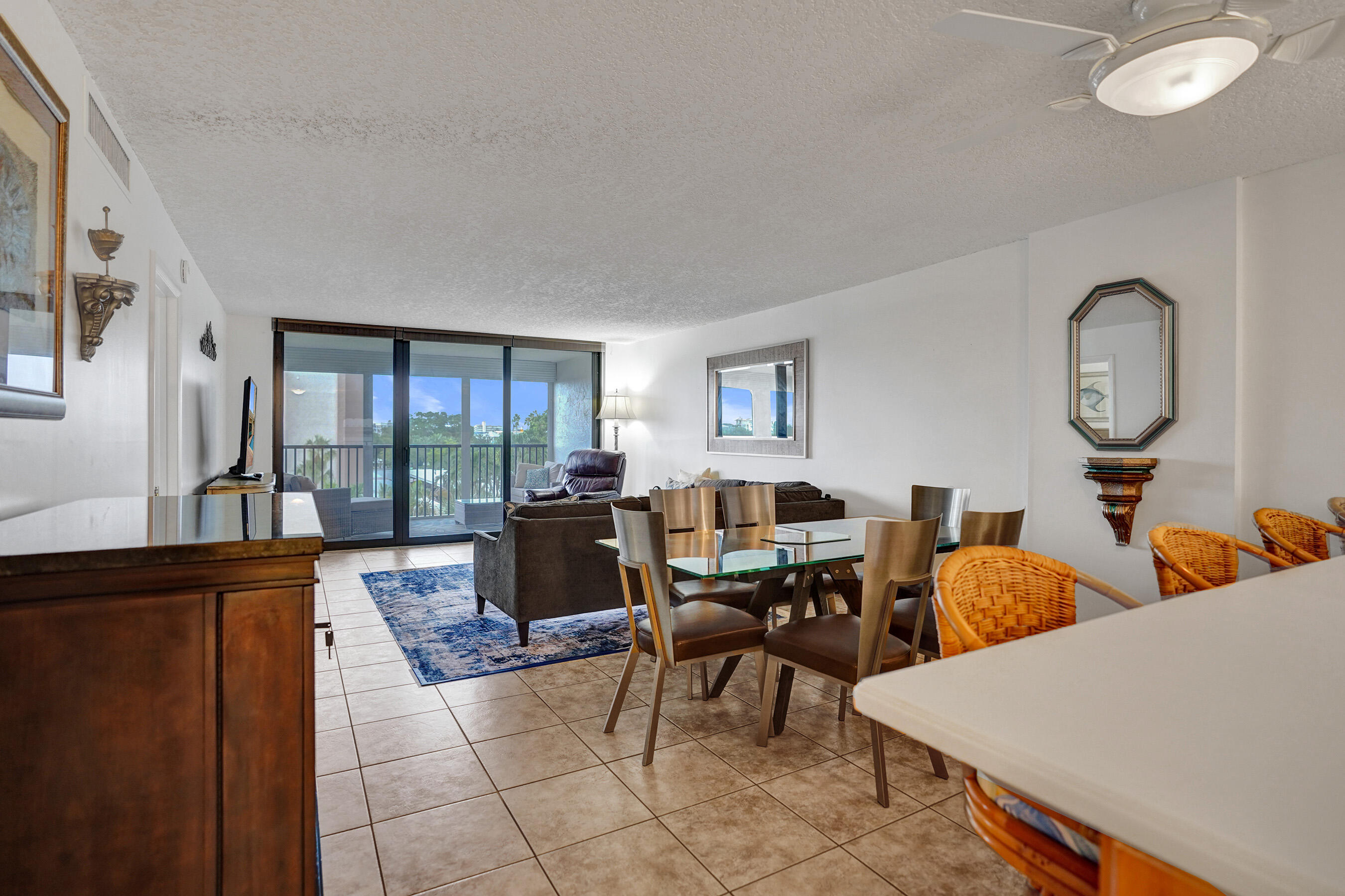 1627 Riverview Road, Unit 410 Deerfield Beach, FL 33441 - Photo 23 of 56 a living room with furniture a lamp and large window