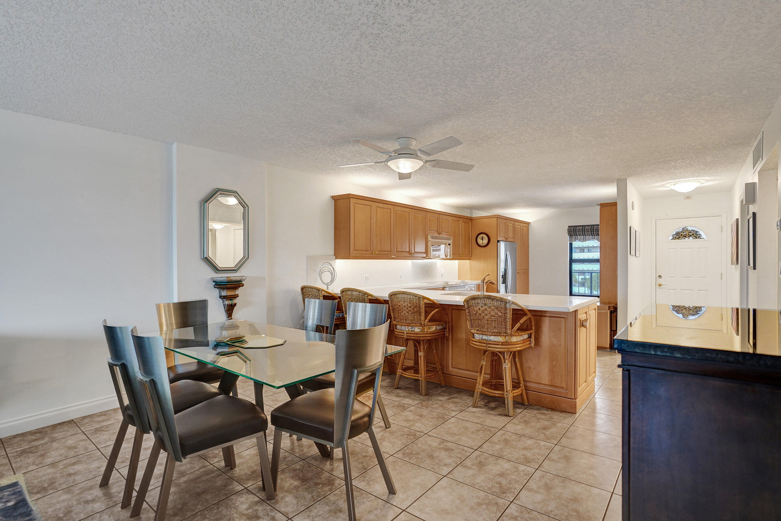1627 Riverview Road, Unit 410 Deerfield Beach, FL 33441 - Photo 24 of 56 a view of a dining room with furniture and a mirror