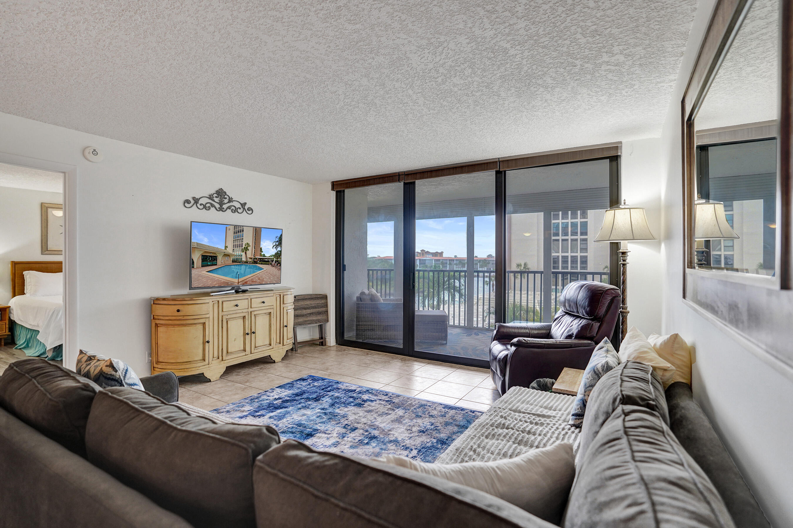1627 Riverview Road, Unit 410 Deerfield Beach, FL 33441 - Photo 27 of 56 a living room with furniture and a flat screen tv