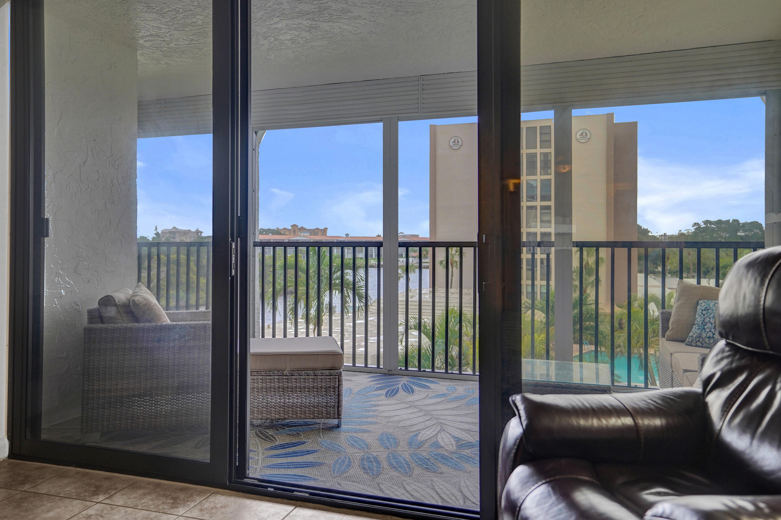 1627 Riverview Road, Unit 410 Deerfield Beach, FL 33441 - Photo 32 of 56 a living room with furniture and a floor to ceiling window