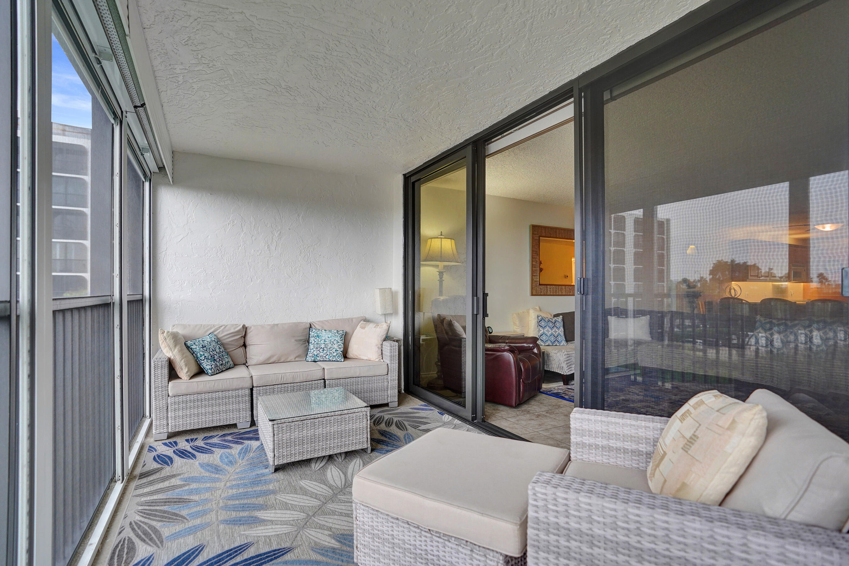 1627 Riverview Road, Unit 410 Deerfield Beach, FL 33441 - Photo 37 of 56 a living room with furniture and a floor to ceiling window