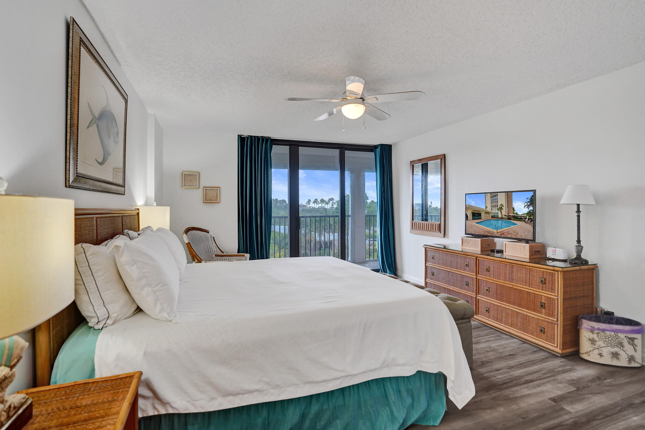 1627 Riverview Road, Unit 410 Deerfield Beach, FL 33441 - Photo 41 of 56 a bedroom with a bed and wooden floor