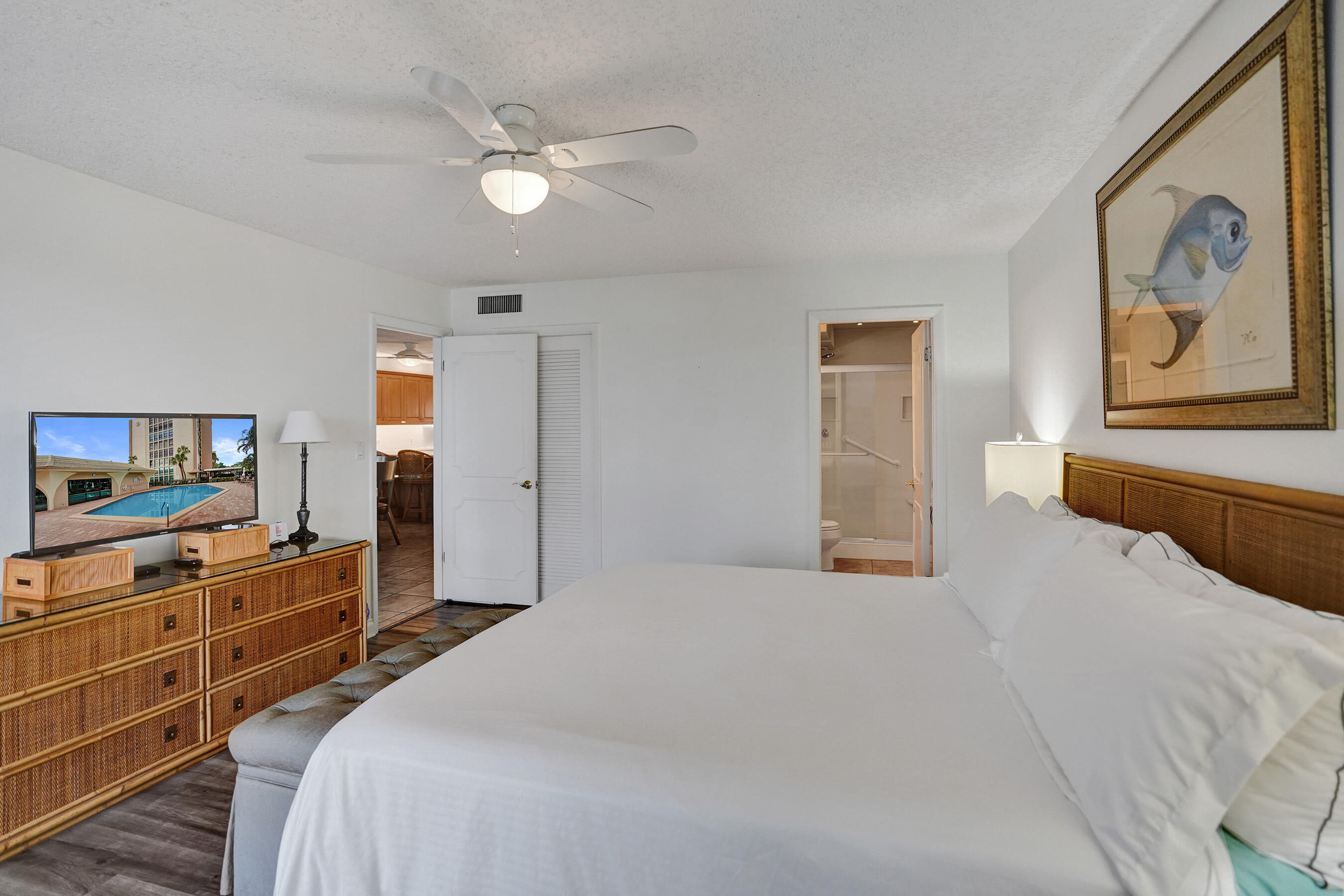 1627 Riverview Road, Unit 410 Deerfield Beach, FL 33441 - Photo 43 of 56 a bedroom with a large bed and a chandelier