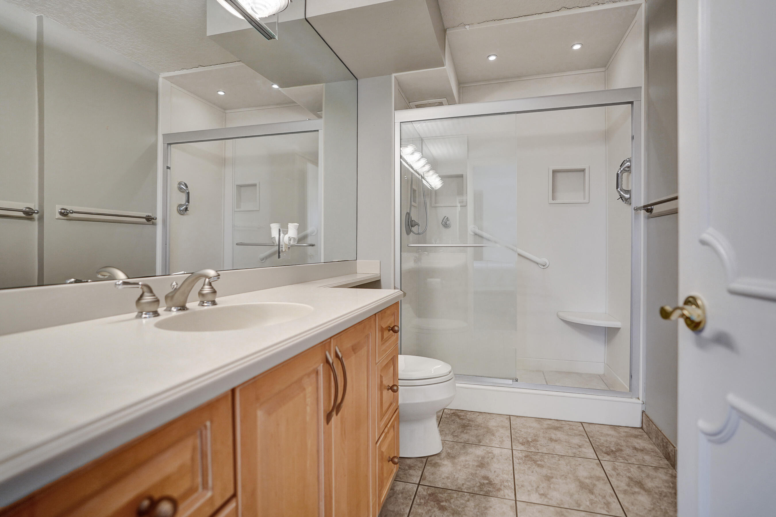 1627 Riverview Road, Unit 410 Deerfield Beach, FL 33441 - Photo 44 of 56 a bathroom with a sink a toilet and shower