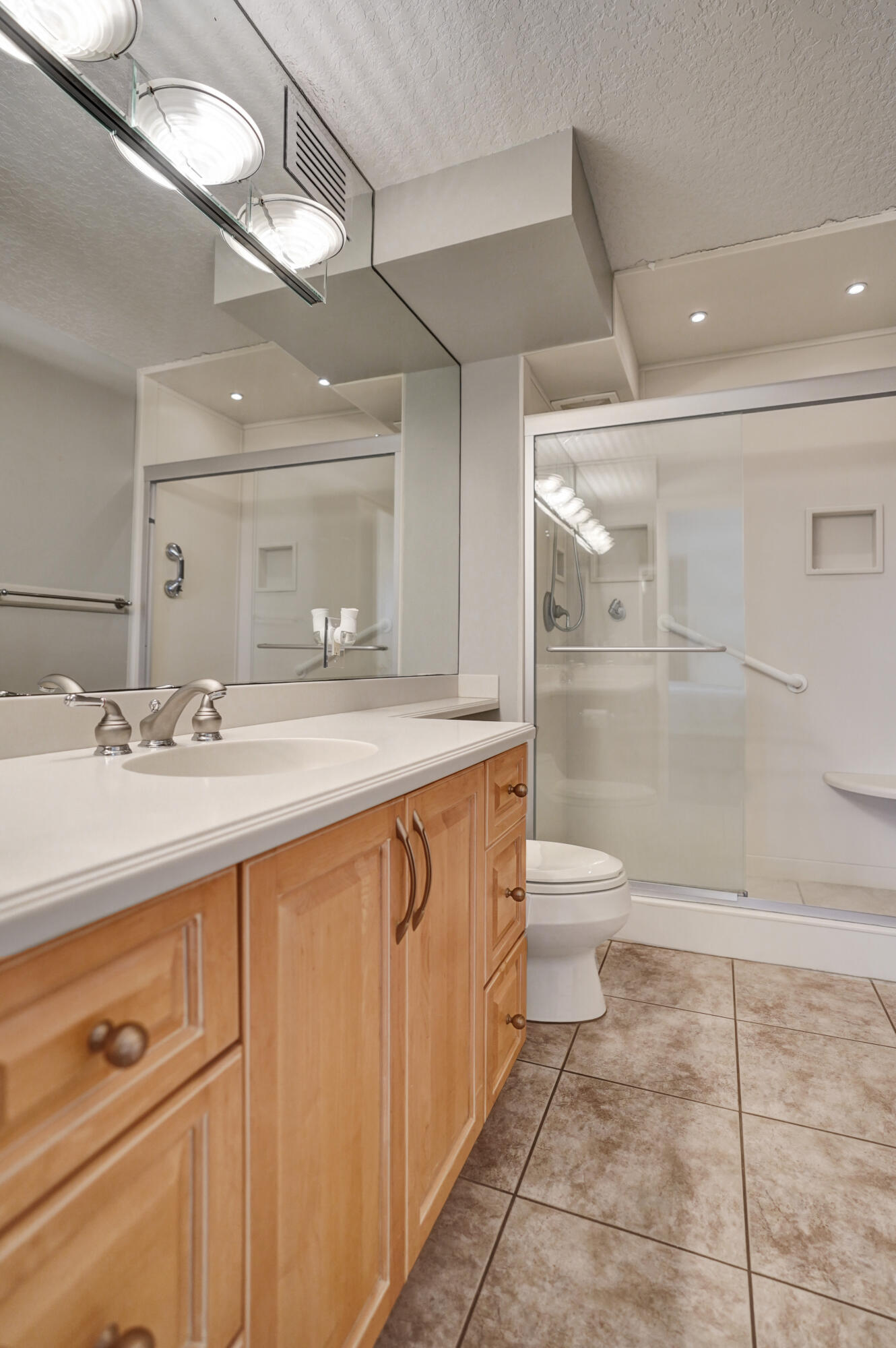 1627 Riverview Road, Unit 410 Deerfield Beach, FL 33441 - Photo 45 of 56 a bathroom with a sink a toilet a mirror and shower