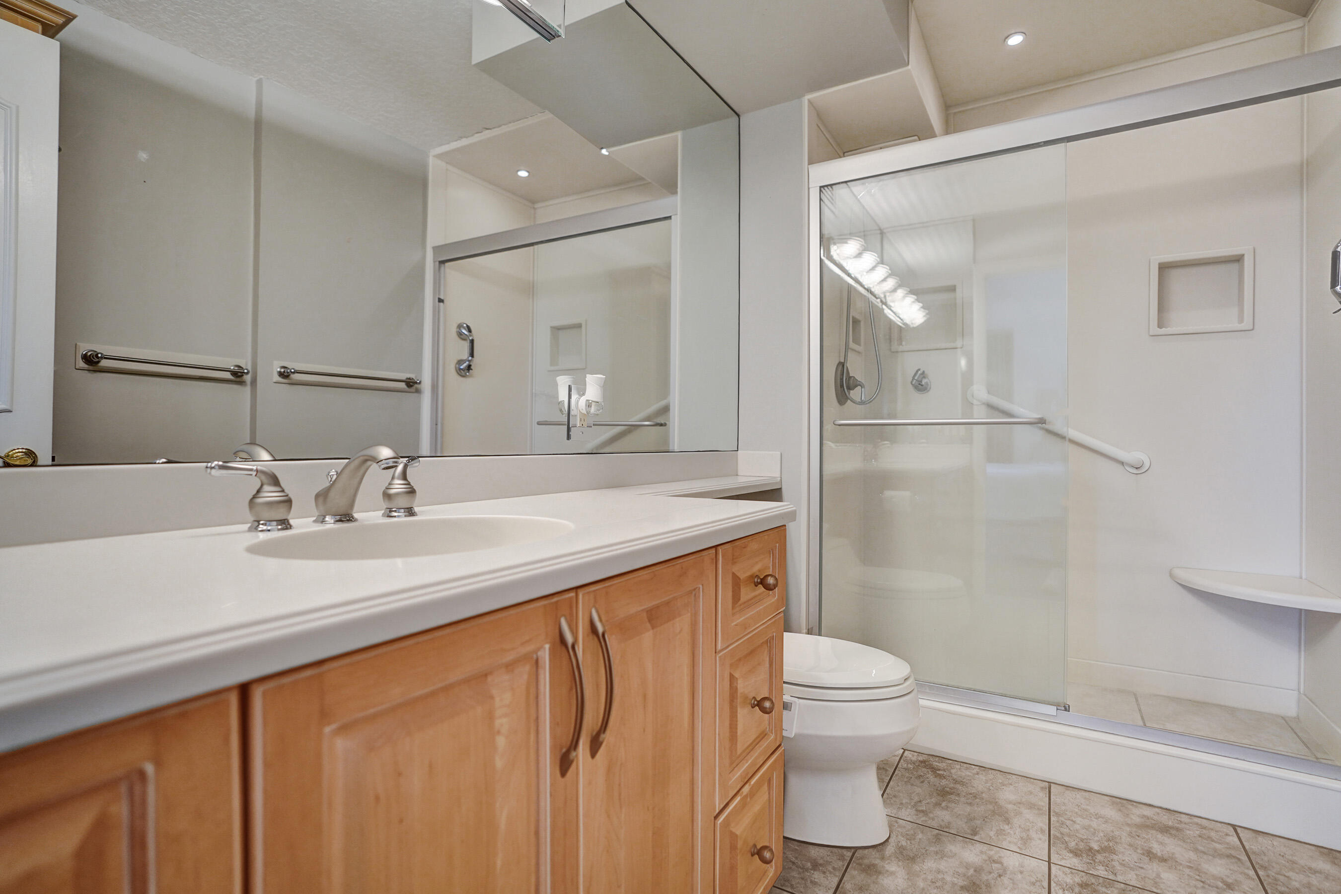 1627 Riverview Road, Unit 410 Deerfield Beach, FL 33441 - Photo 46 of 56 a bathroom with a sink a toilet and shower