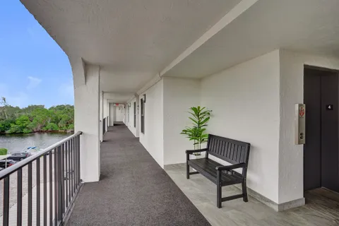 a view of a building with a big yard and plants