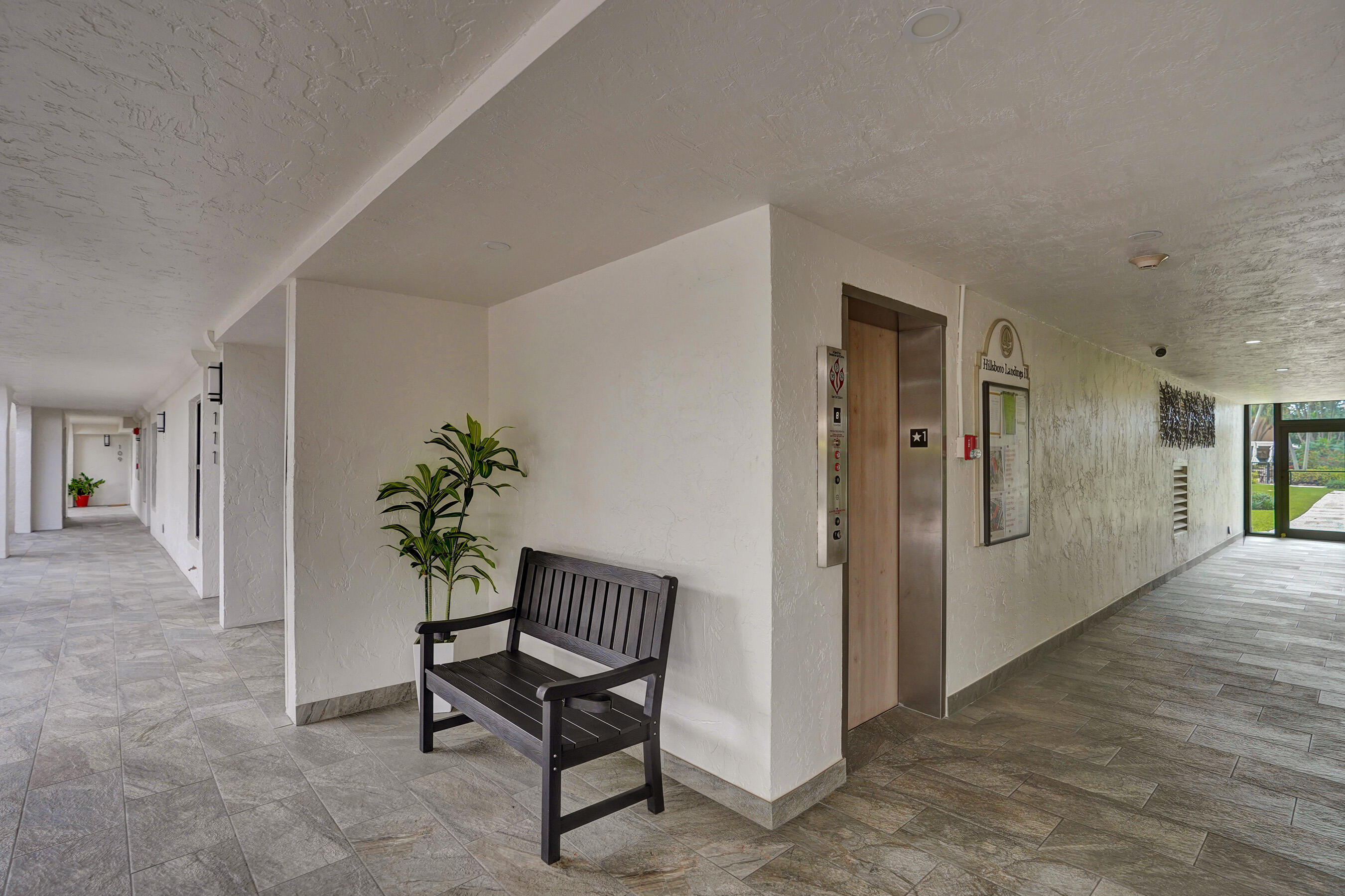 1627 Riverview Road, Unit 410 Deerfield Beach, FL 33441 - Photo 5 of 56 a view of an entryway with wooden floor and a potted plant