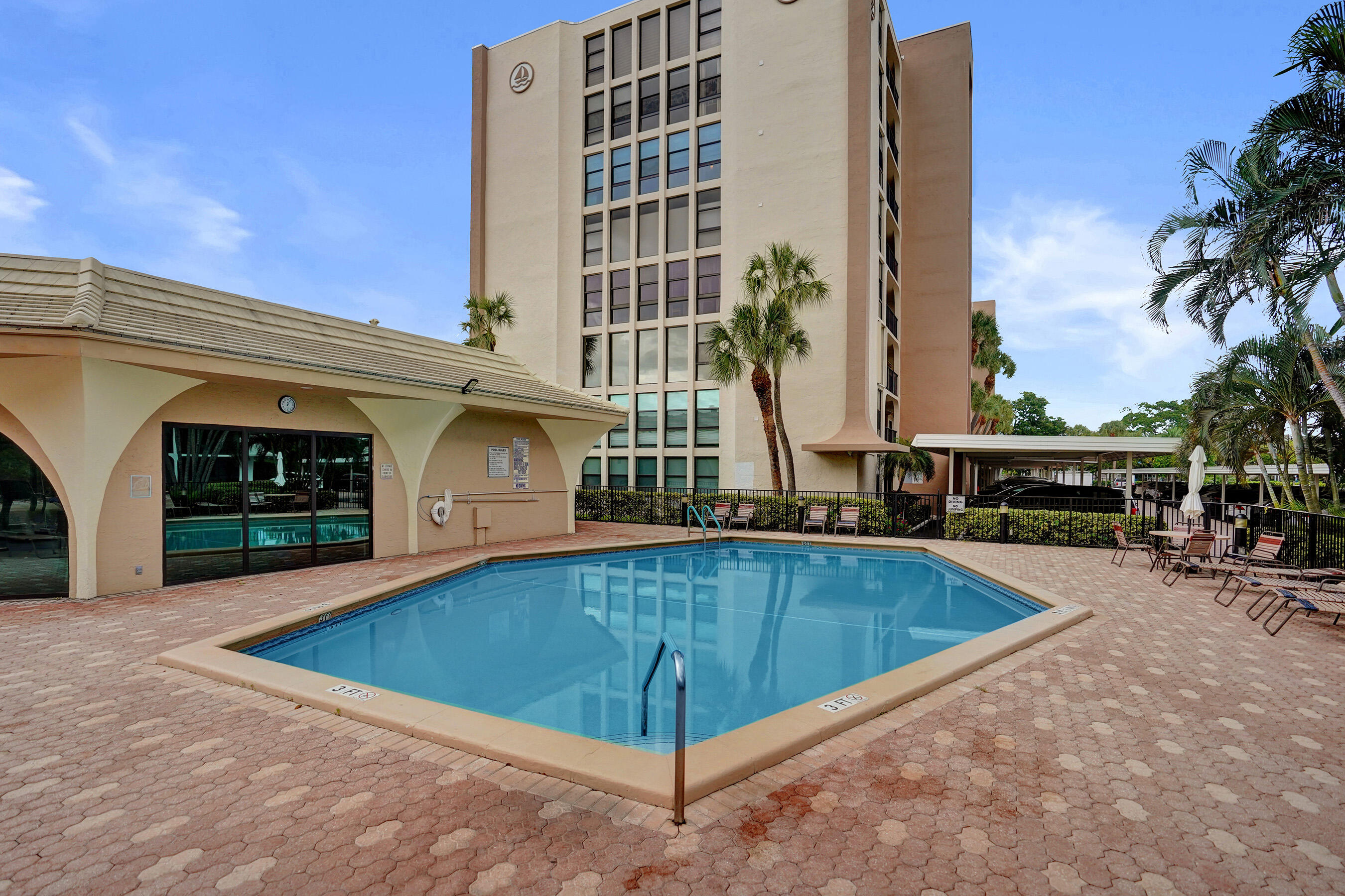 1627 Riverview Road, Unit 410 Deerfield Beach, FL 33441 - Photo 51 of 56 a view of a swimming pool with a chair