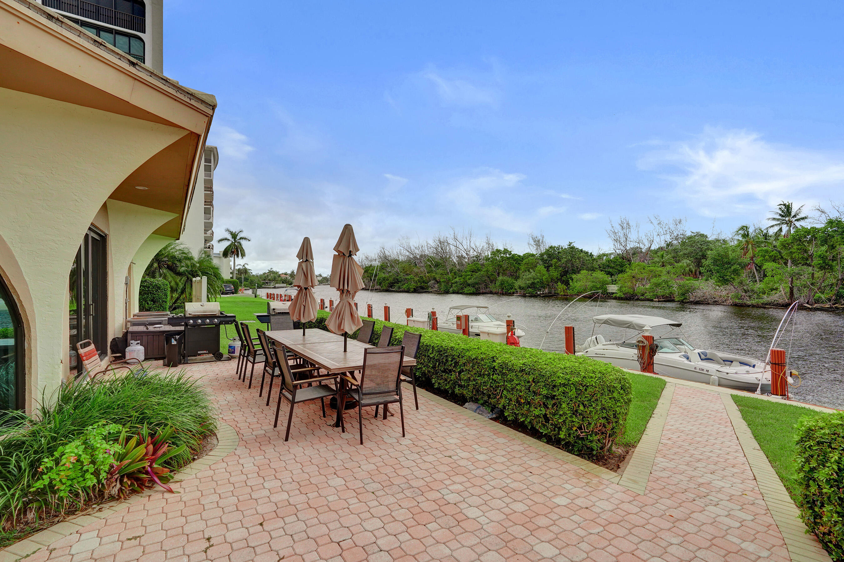 1627 Riverview Road, Unit 410 Deerfield Beach, FL 33441 - Photo 55 of 56 a view of a patio with chair and table of the backyard