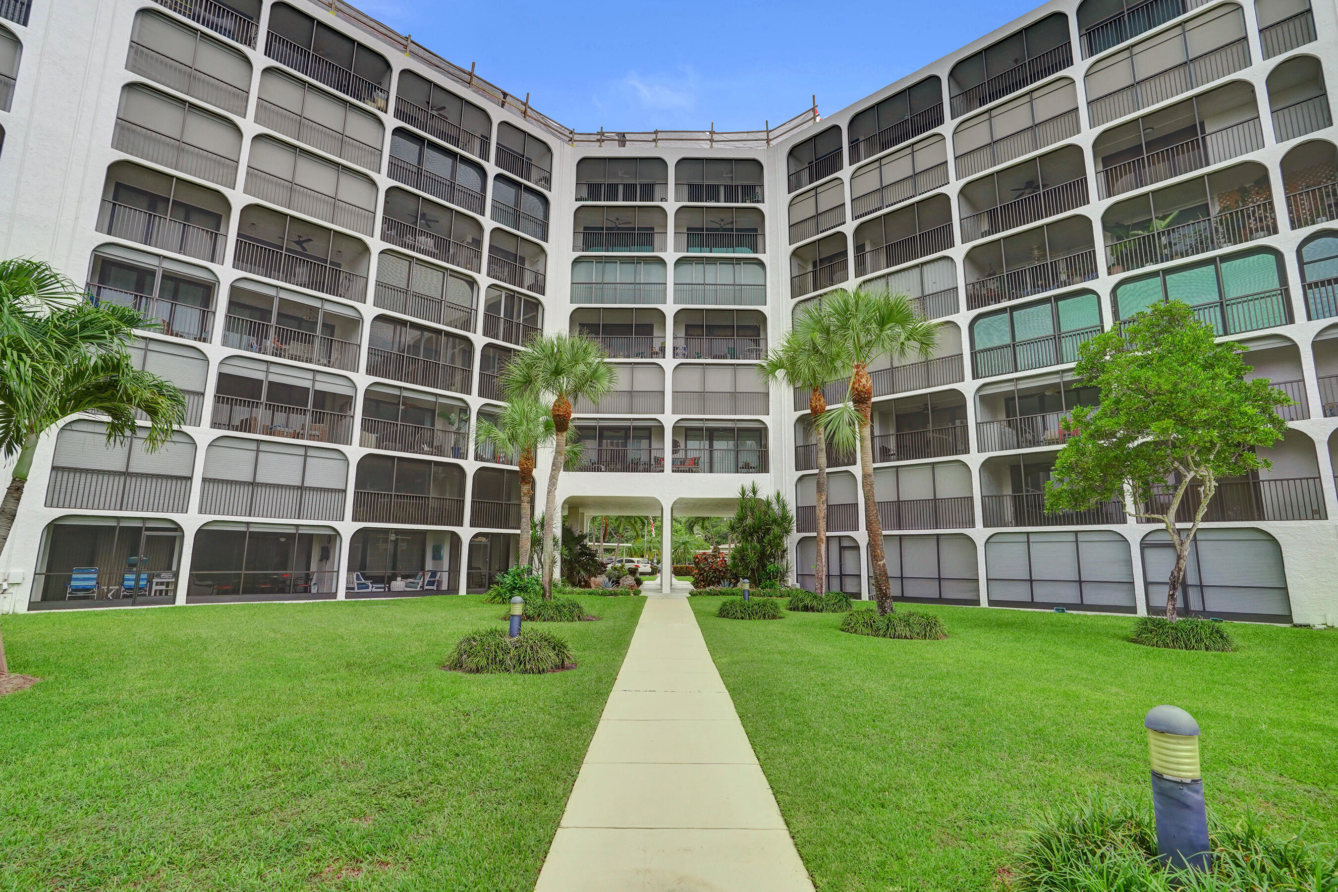 1627 Riverview Road, Unit 410 Deerfield Beach, FL 33441 - Photo 56 of 56 a view of a building with a big yard and plants