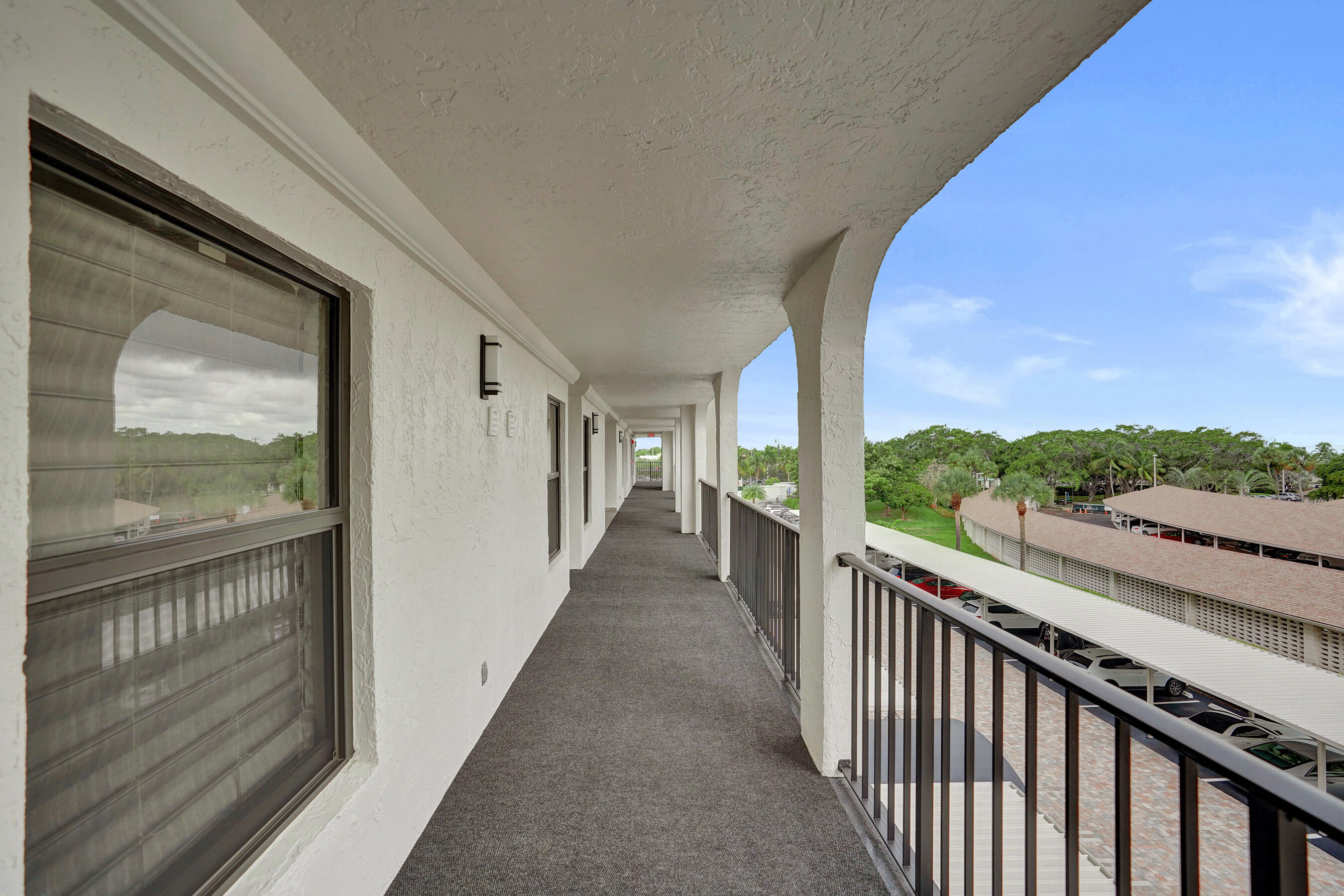 1627 Riverview Road, Unit 410 Deerfield Beach, FL 33441 - Photo 8 of 56 a view of a balcony with wooden floor and city view