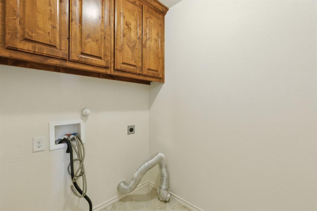 233 Firefly Drive Springtown, TX 76082 - Photo 16 of 16 Utility room featuring overhead wood cabinetry