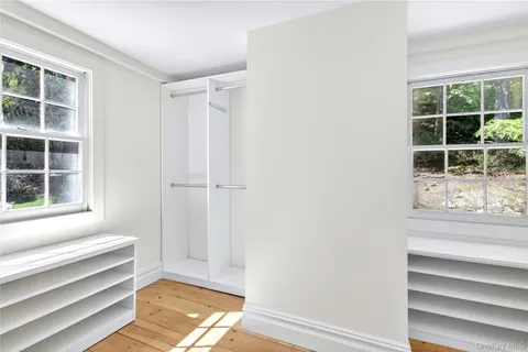 a view of front door with wooden floor and windows