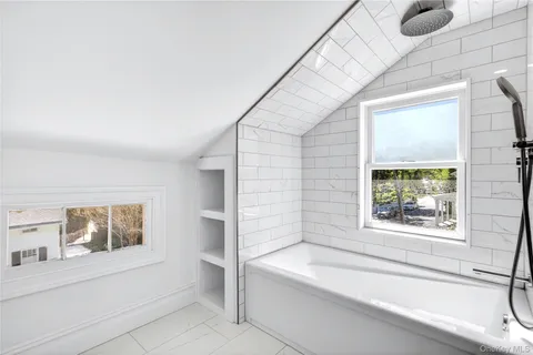 a bathroom with a bathtub and window