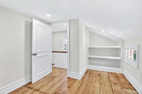 a view of a room with wooden floor and closet