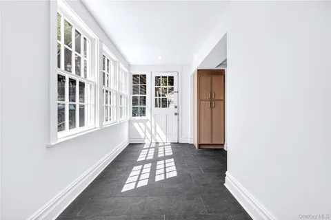 a view of an entryway with wooden floor